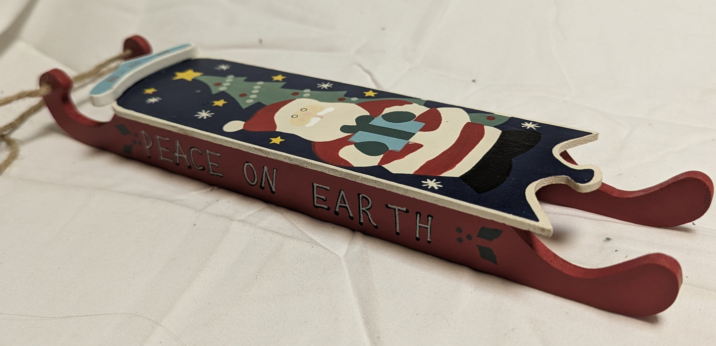 Ornament Christmas Painted Wood Santa Delivering Package at night in front of Christmas tree