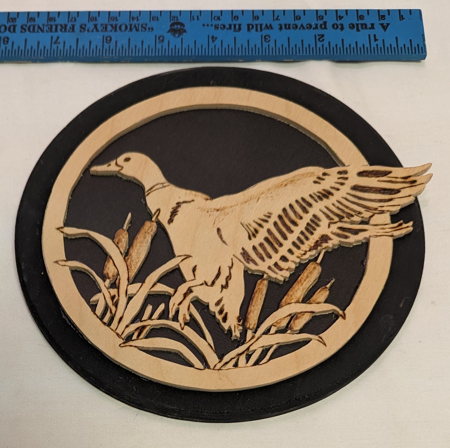 Art Pyrography and Hand Scroll Sawed Duck in flight through cat tails of wood