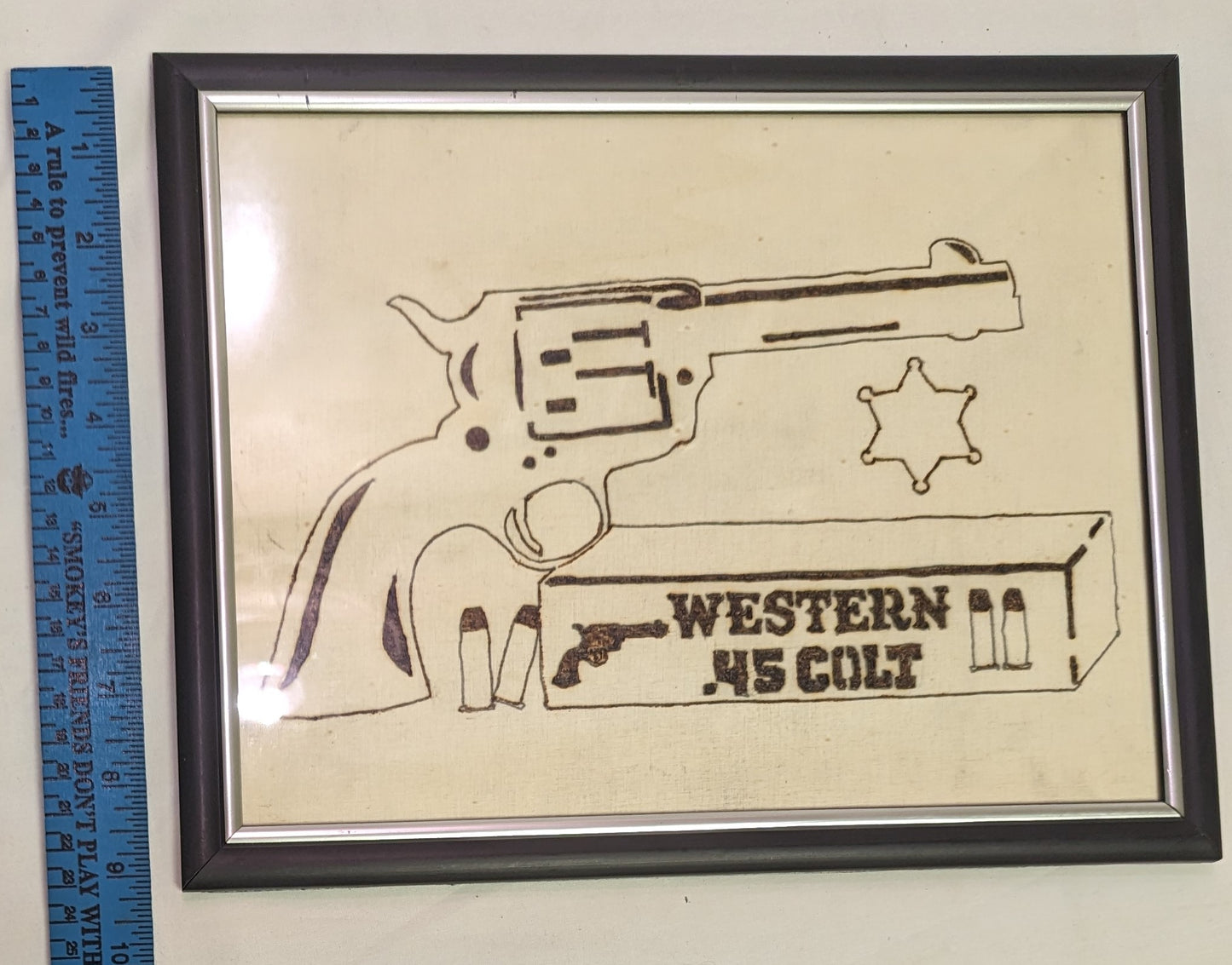 Art Pyrography Pistol and Shells Emblem on wood in frame under glass