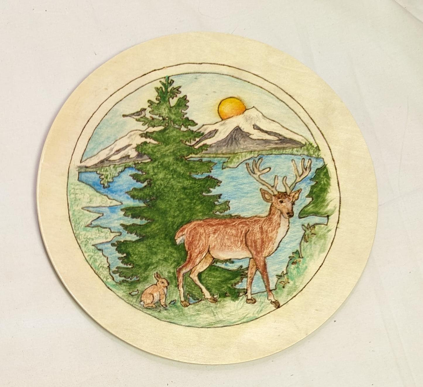 Art Pyrography painted filled on round wood. Buck and Bunny Mountain Scene