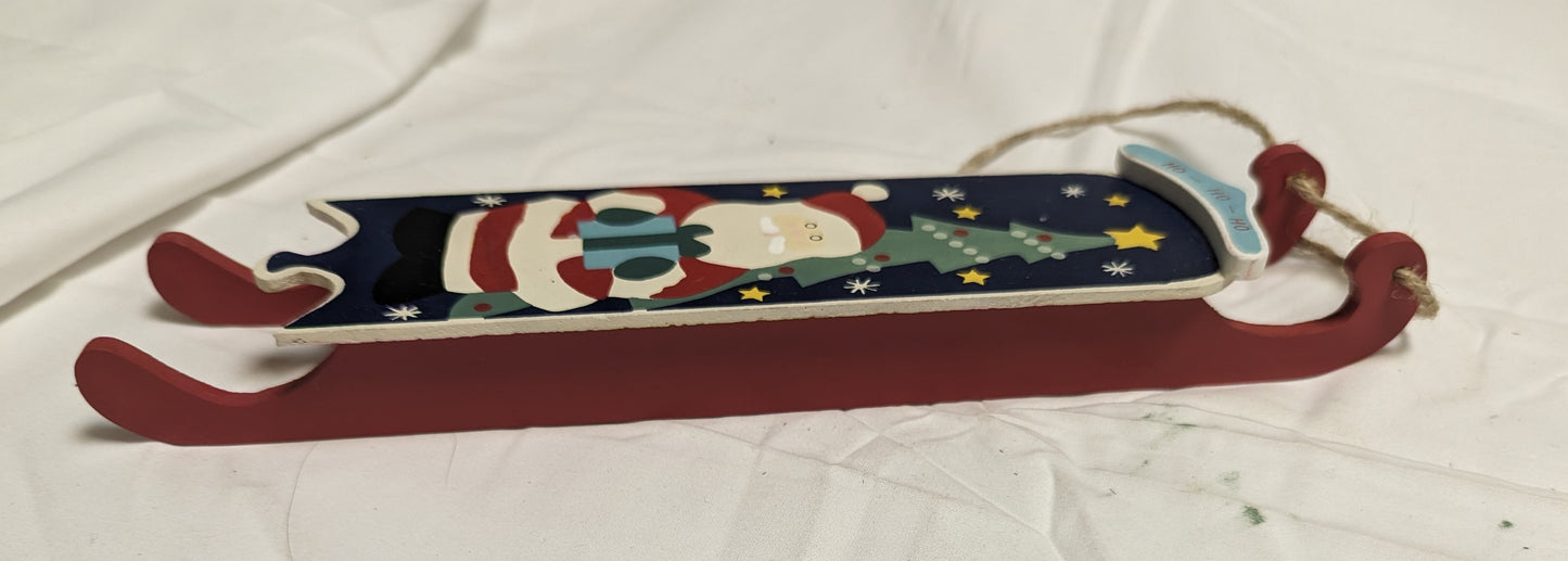 Ornament Christmas Painted Wood Santa Delivering Package at night in front of Christmas tree