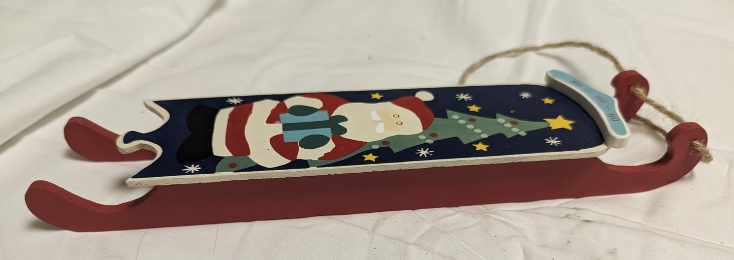 Ornament Christmas Painted Wood Santa Delivering Package at night in front of Christmas tree