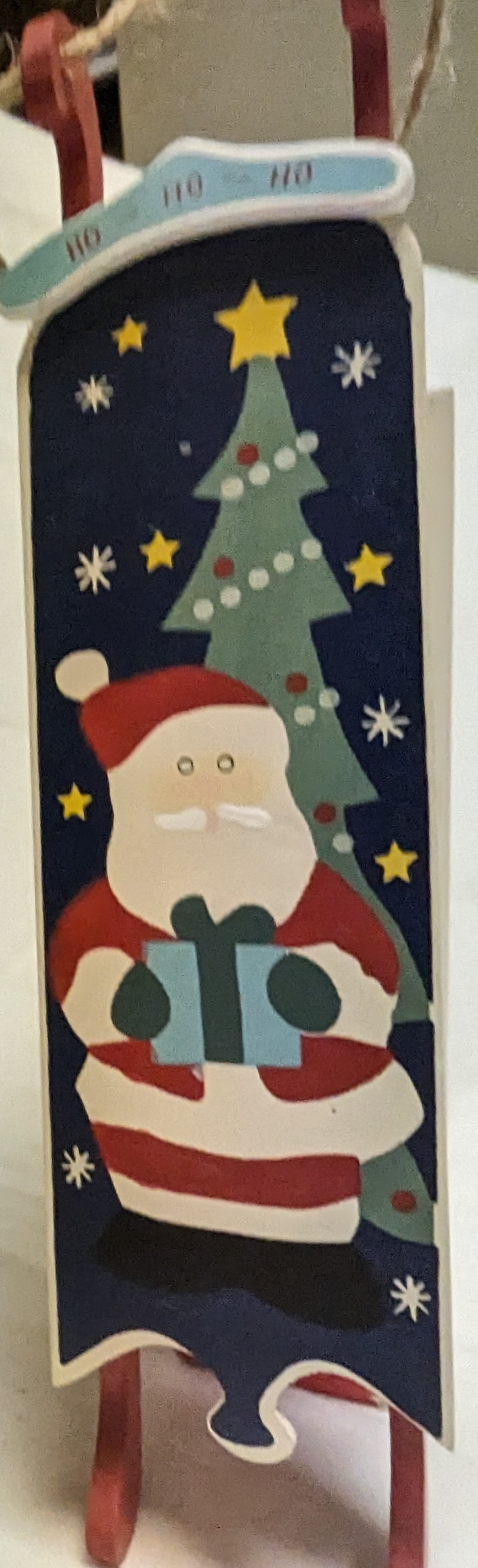 Ornament Christmas Painted Wood Santa Delivering Package at night in front of Christmas tree