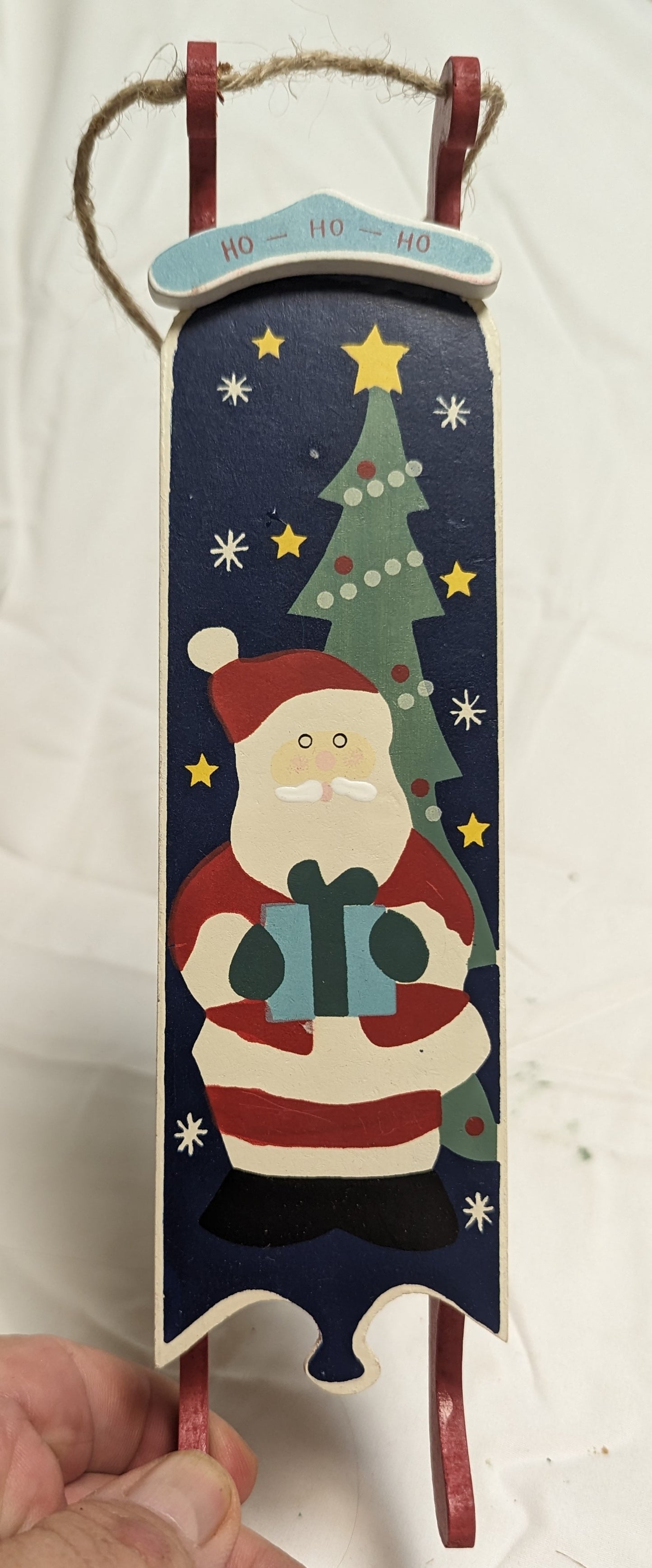 Ornament Christmas Painted Wood Santa Delivering Package at night in front of Christmas tree