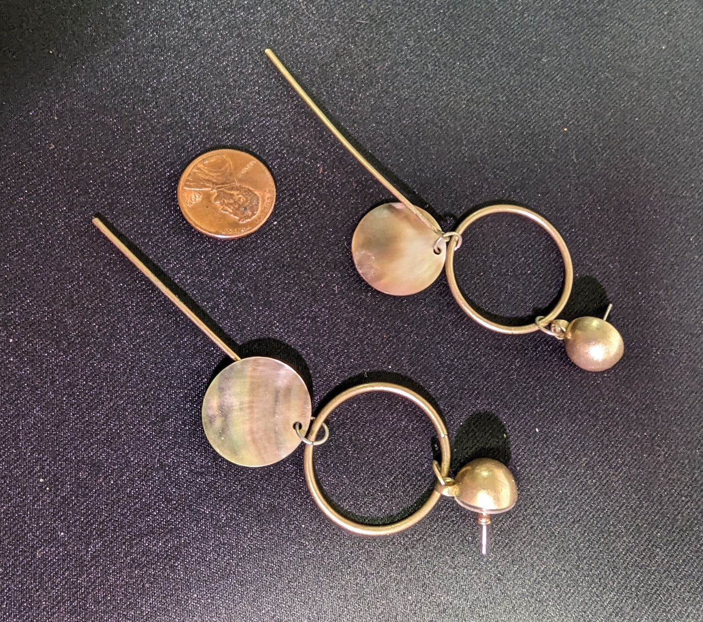 Earrings Unique Metal geometrics with round hanging abalone.