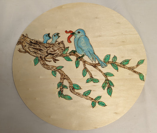 Art Pyrography color filled Bluebird feeding chicks on round wood board