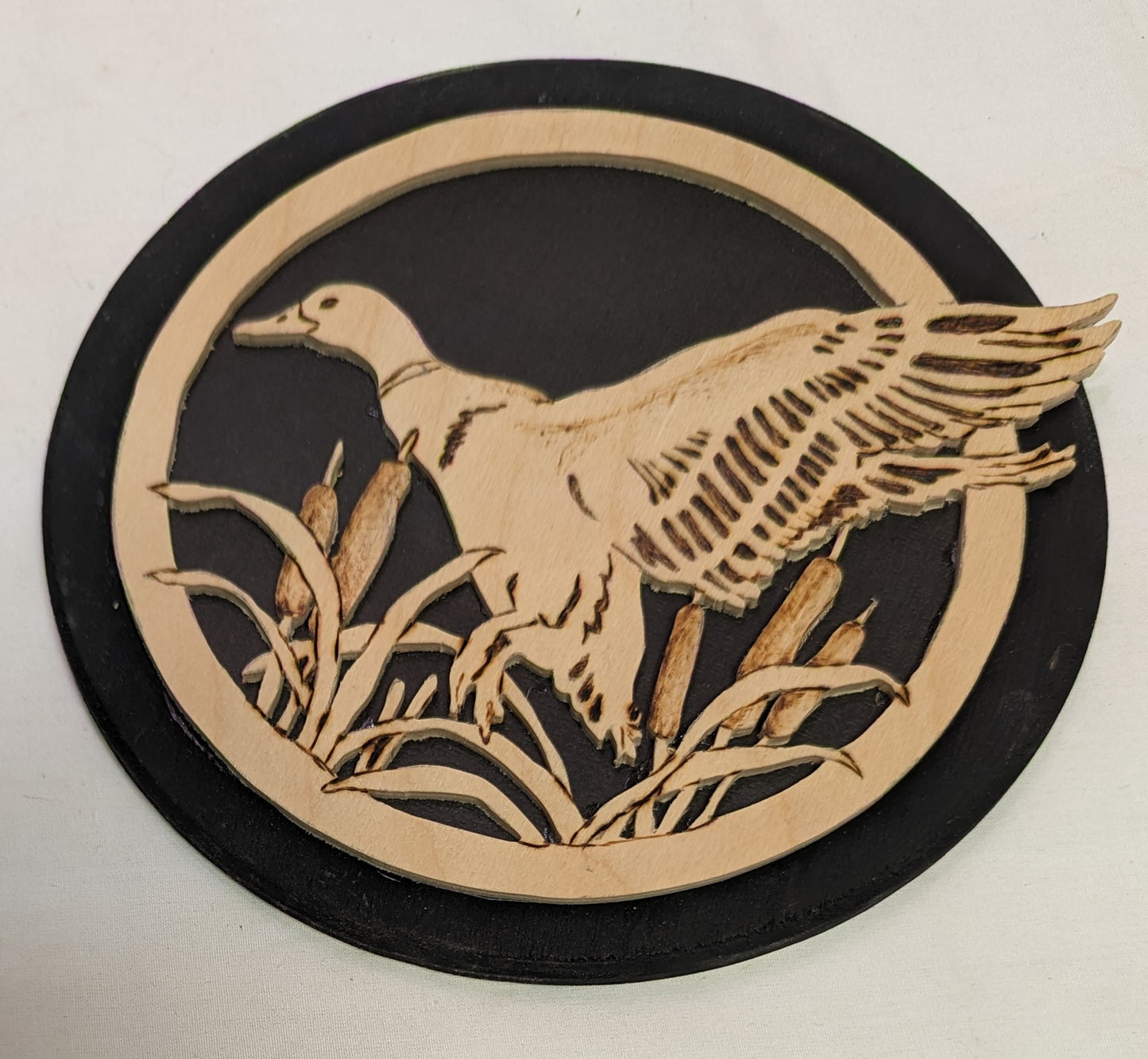 Art Pyrography and Hand Scroll Sawed Duck in flight through cat tails of wood