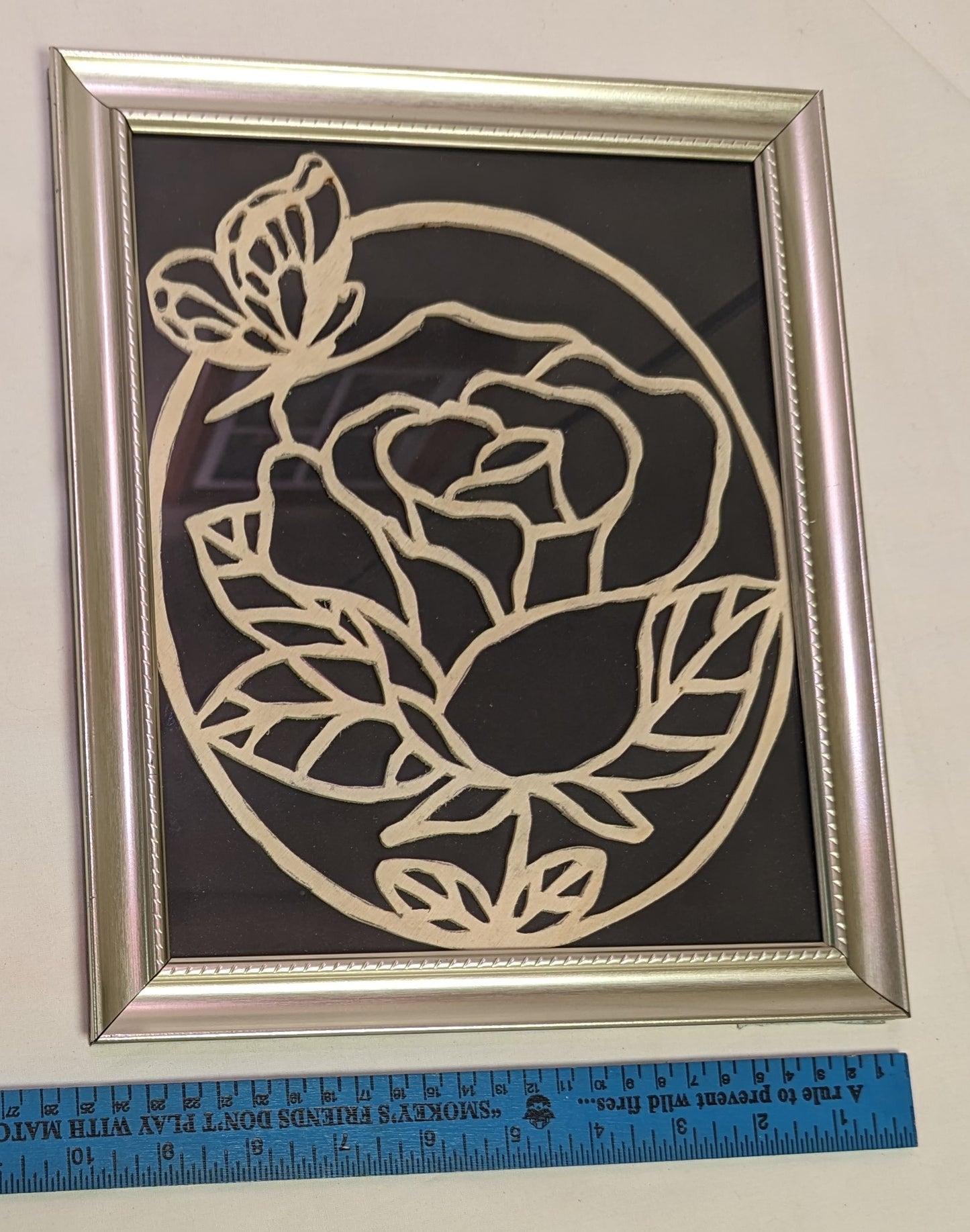 Art Scroll Saw Flower and Butterfly Cut over Black Background in Frame under glass
