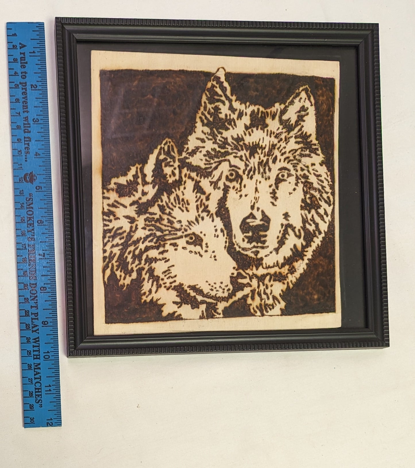 Art Pyrography Burned by hand Wolves faces in a frame