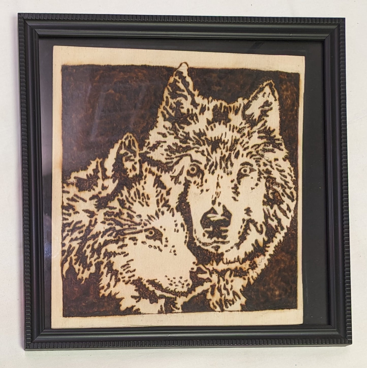 Art Pyrography Burned by hand Wolves faces in a frame