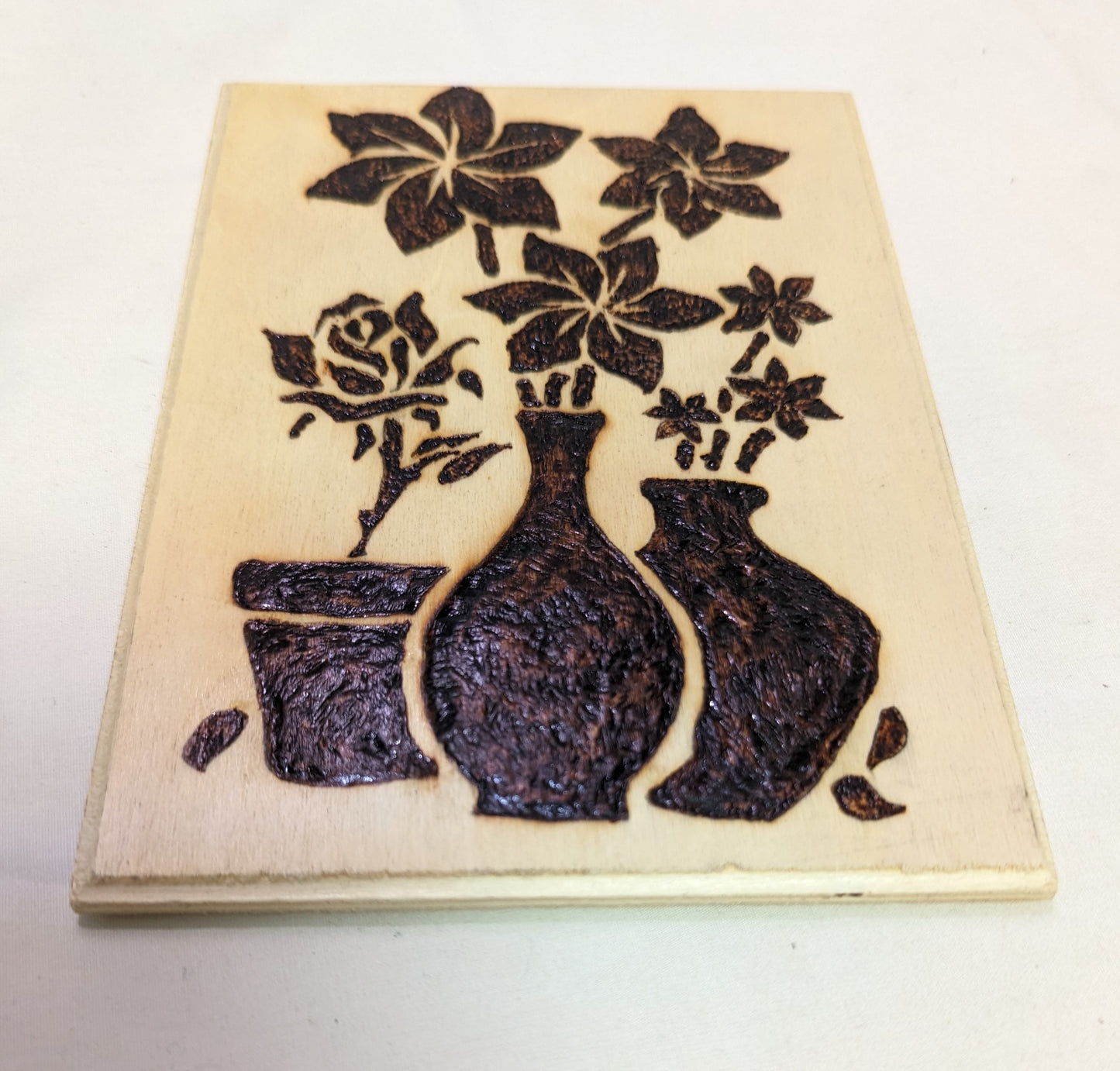 Art Pyrography on wood Flowers in pots emblem negative style