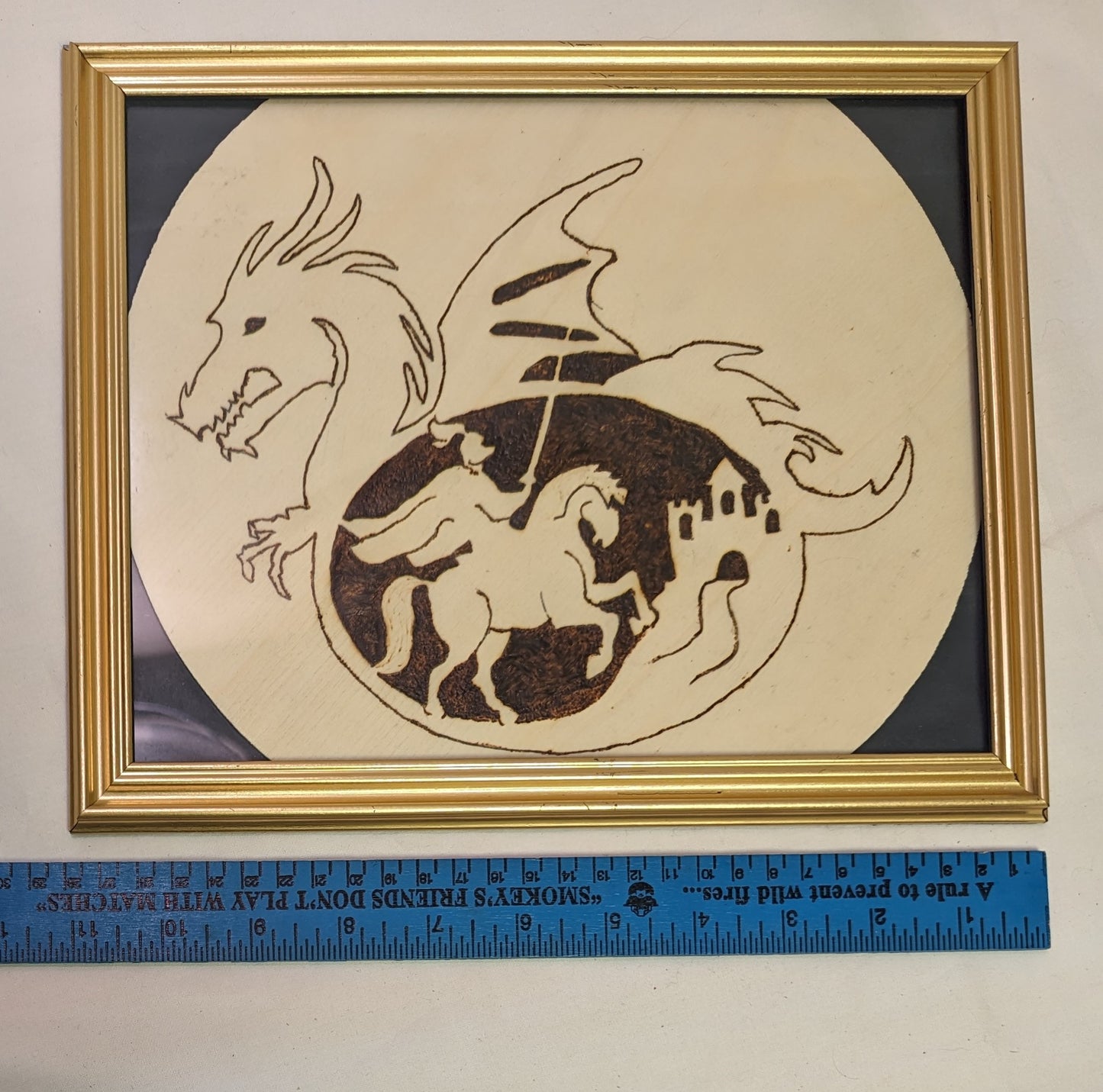 Art Pyrography on round wood Emblem Knoght in Dragon in frame under glass