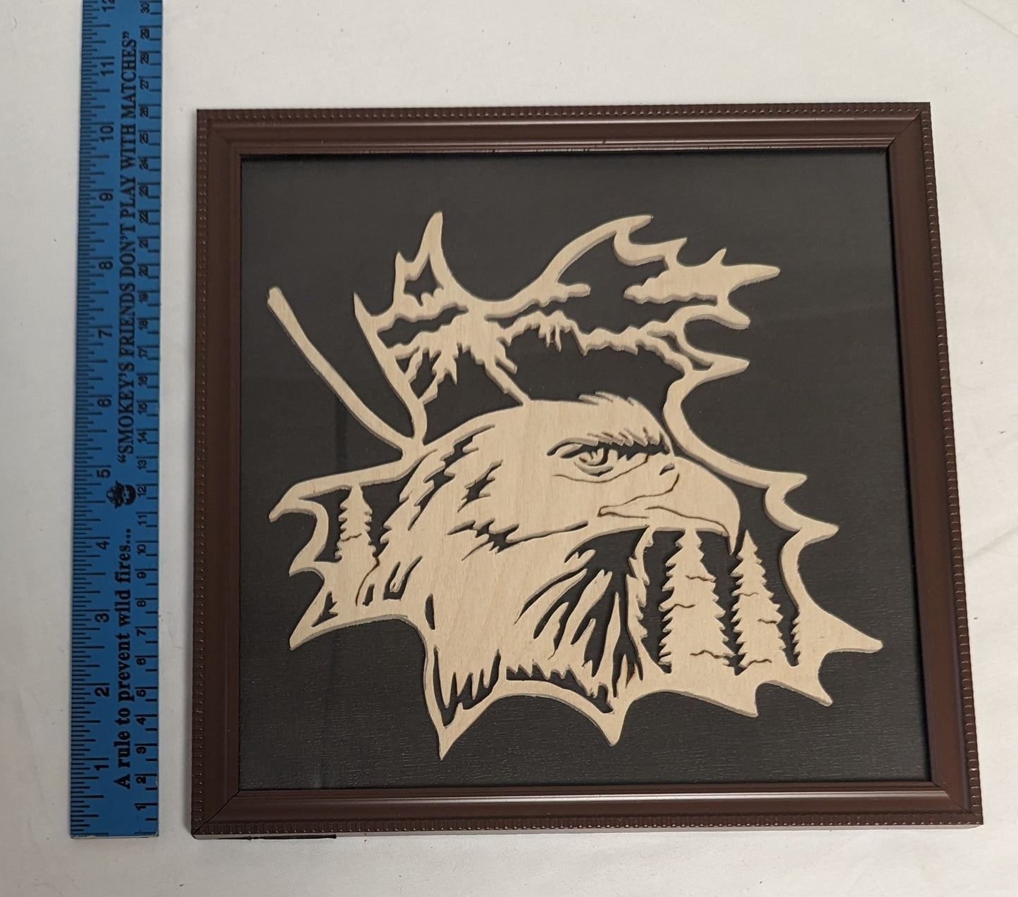 Art Hand Scroll Sawn A"Eagle on Maple Leaf Emblem" in frame under glass