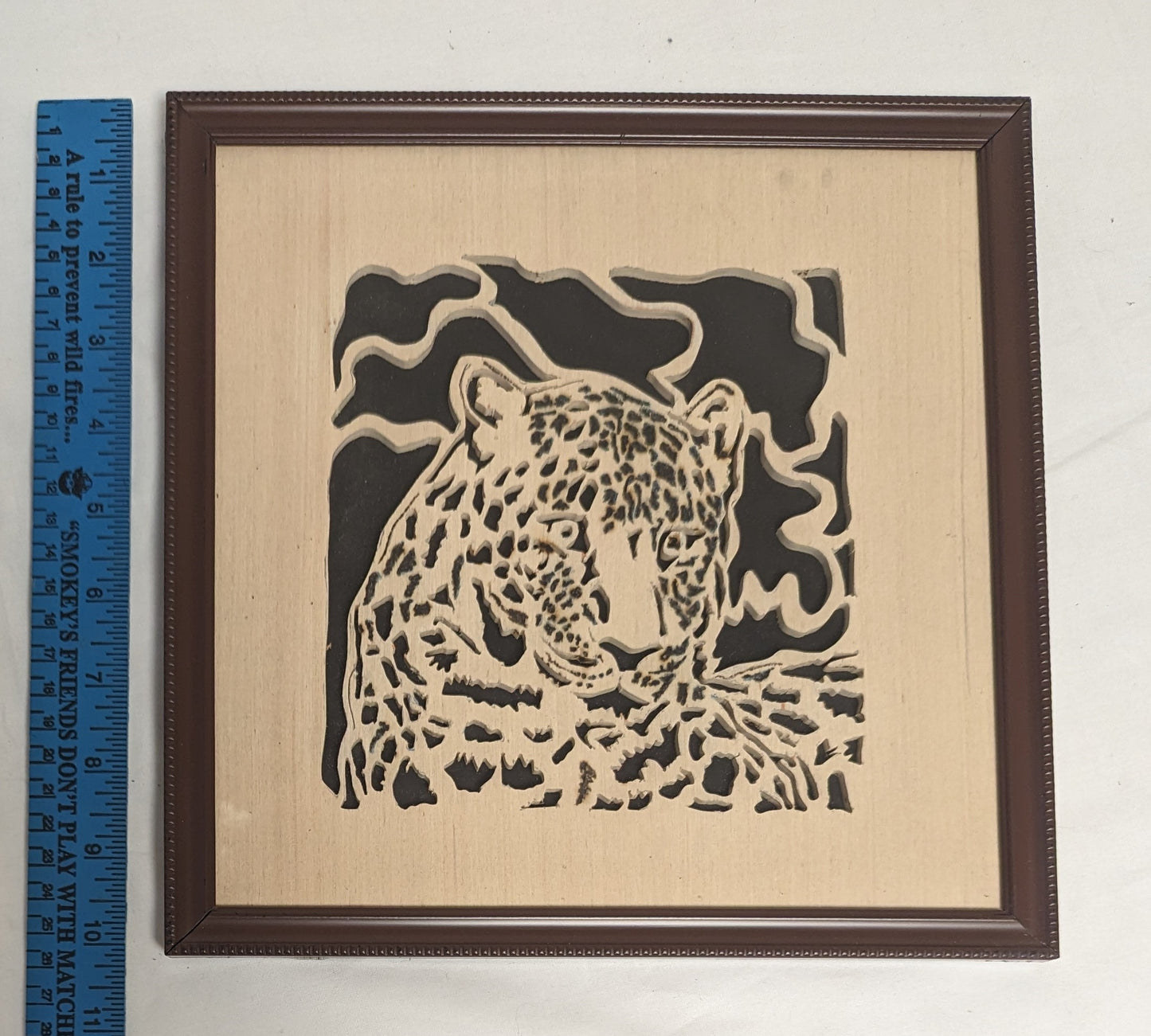 Art Hand Scroll Sawn Leopard Cut Out " in frame under glass