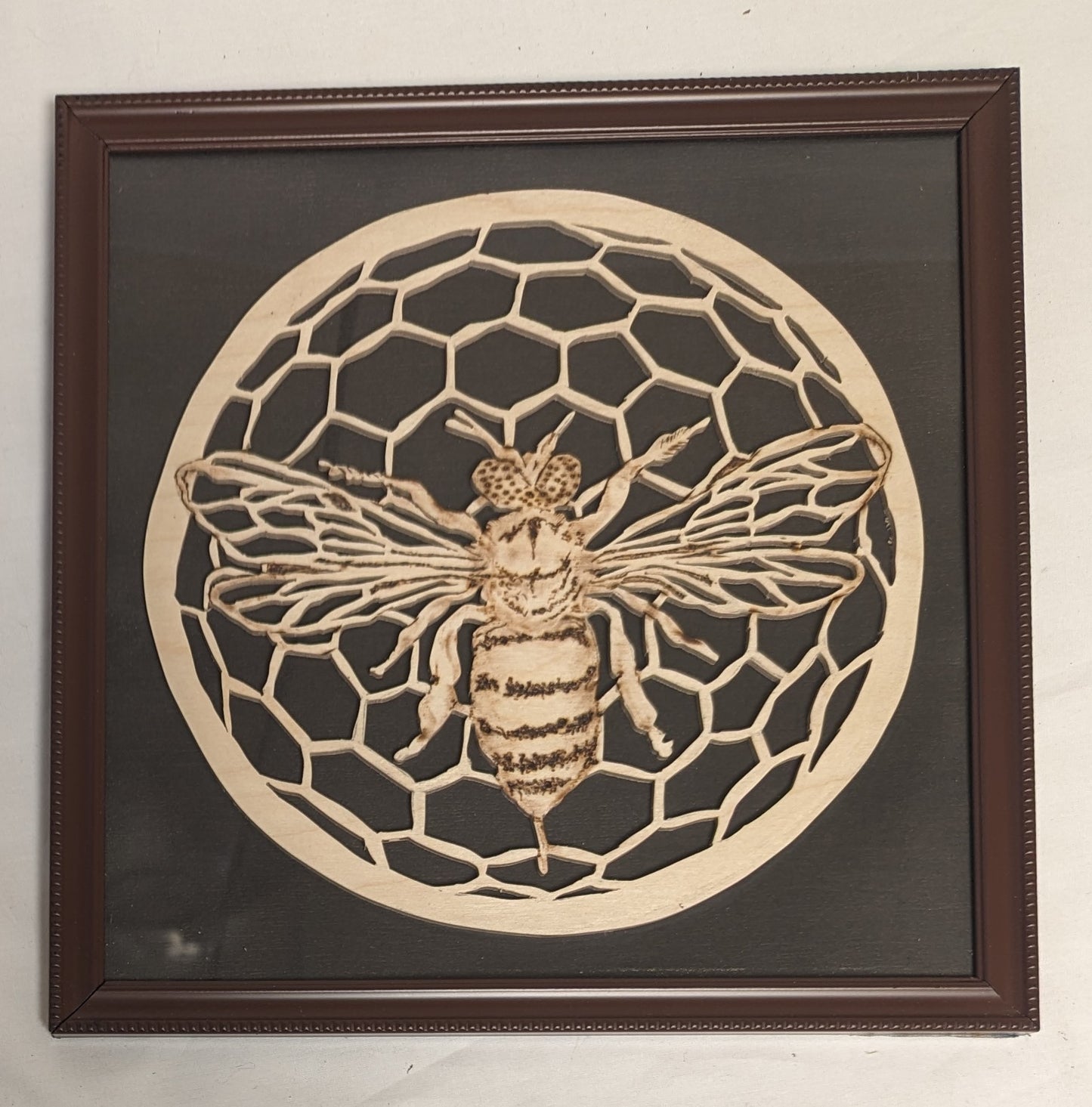 Art Hand Scroll Sawn Delicate "Bee on Comb" Emblem in frame under glass