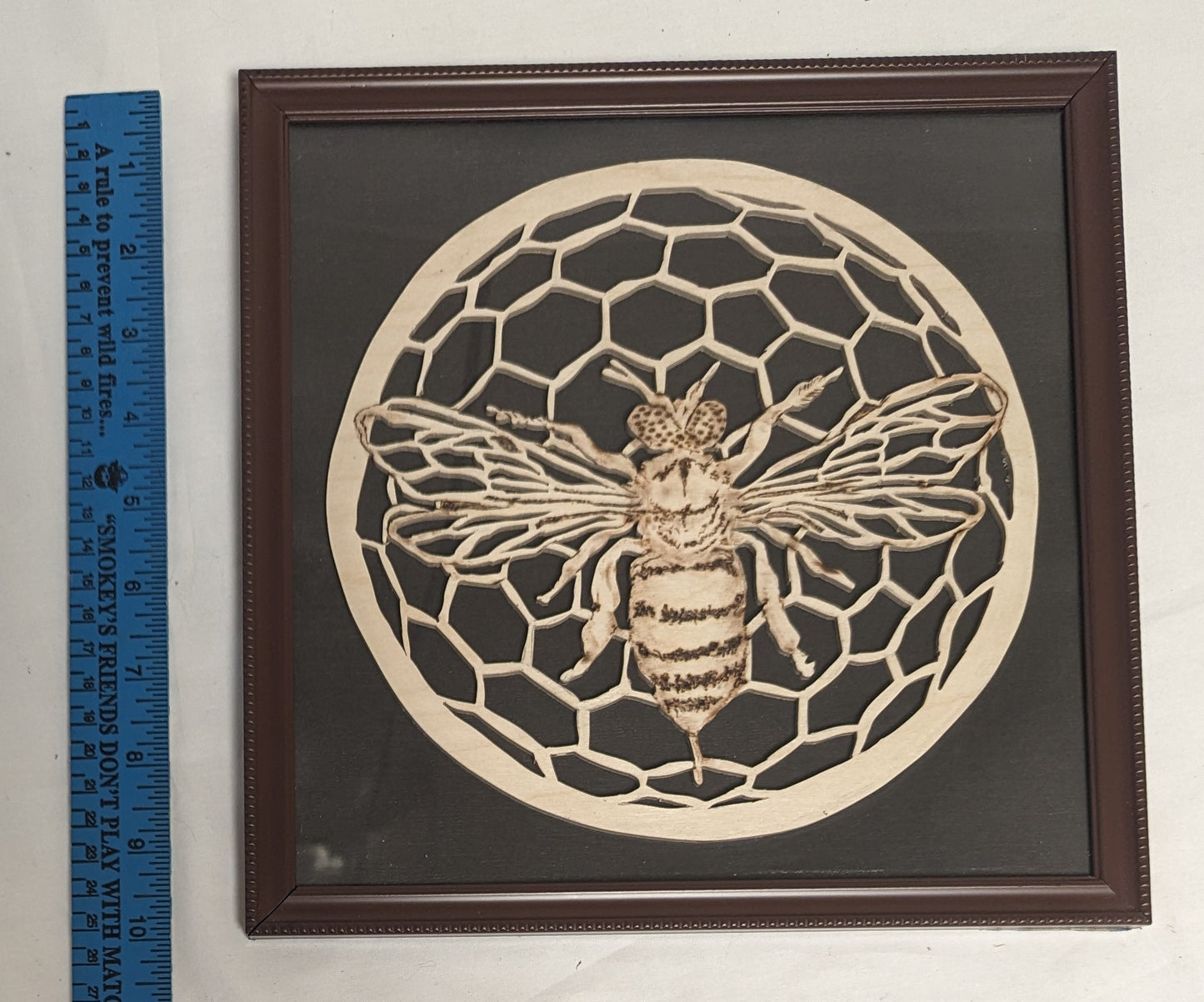 Art Hand Scroll Sawn Delicate "Bee on Comb" Emblem in frame under glass