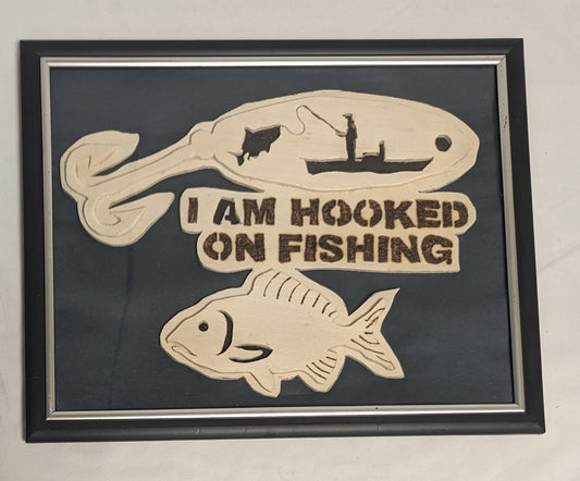 Art Handmade Scroll sawn Pyrography on wood sign " Hooked on Fishing"  in frame under glass.