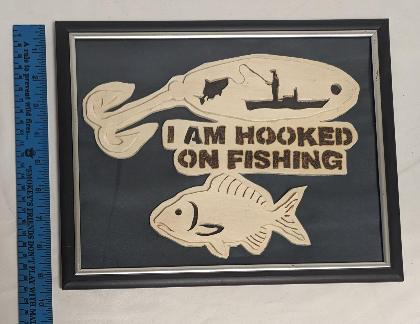 Art Handmade Scroll sawn Pyrography on wood sign " Hooked on Fishing"  in frame under glass.