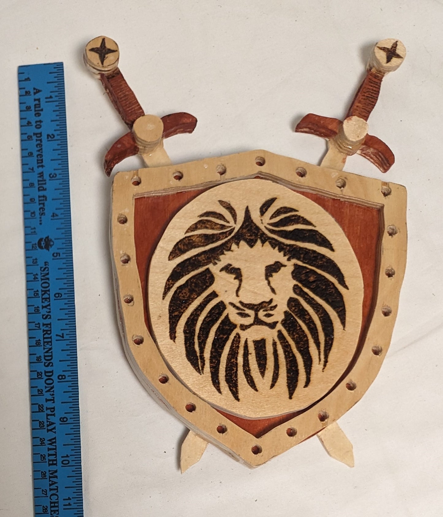 Art Handmade scroll sawn Pyrography on wood "Lionhead Arms" swords and sheild  wall hanging